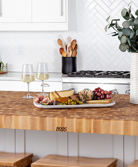 Kitchen with John Boos wood countertops and charcuterie board and wine glasses