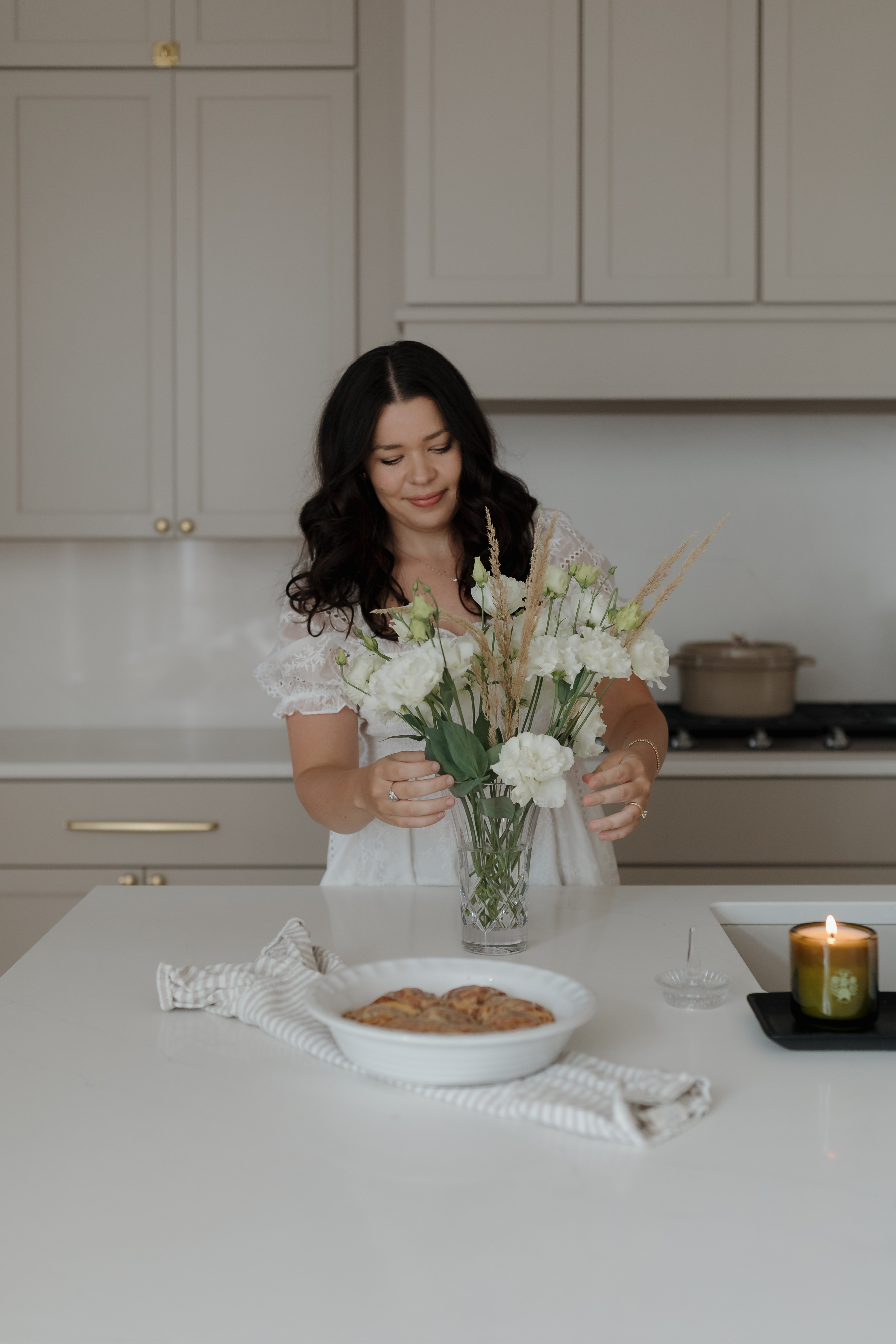 Whitney Malish organizing a vase of flowers